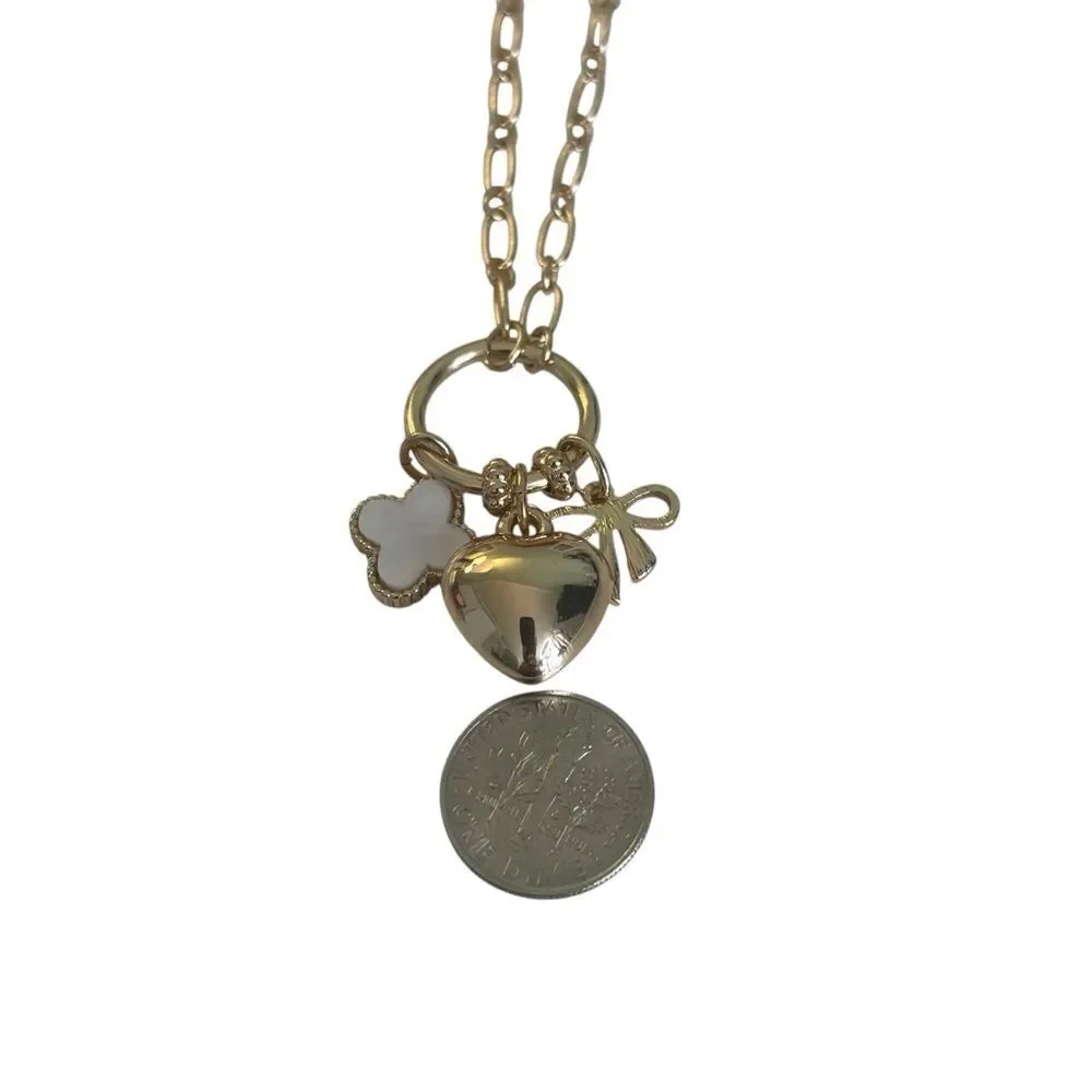 Gold Tone Multi-Charm Necklace w/ Puffy Heart, White Clocer & Gold Bow.